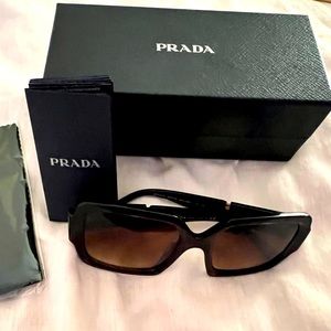 Prada sunglasses like new. Comes with case, box, eyeglass cloth and cary case.